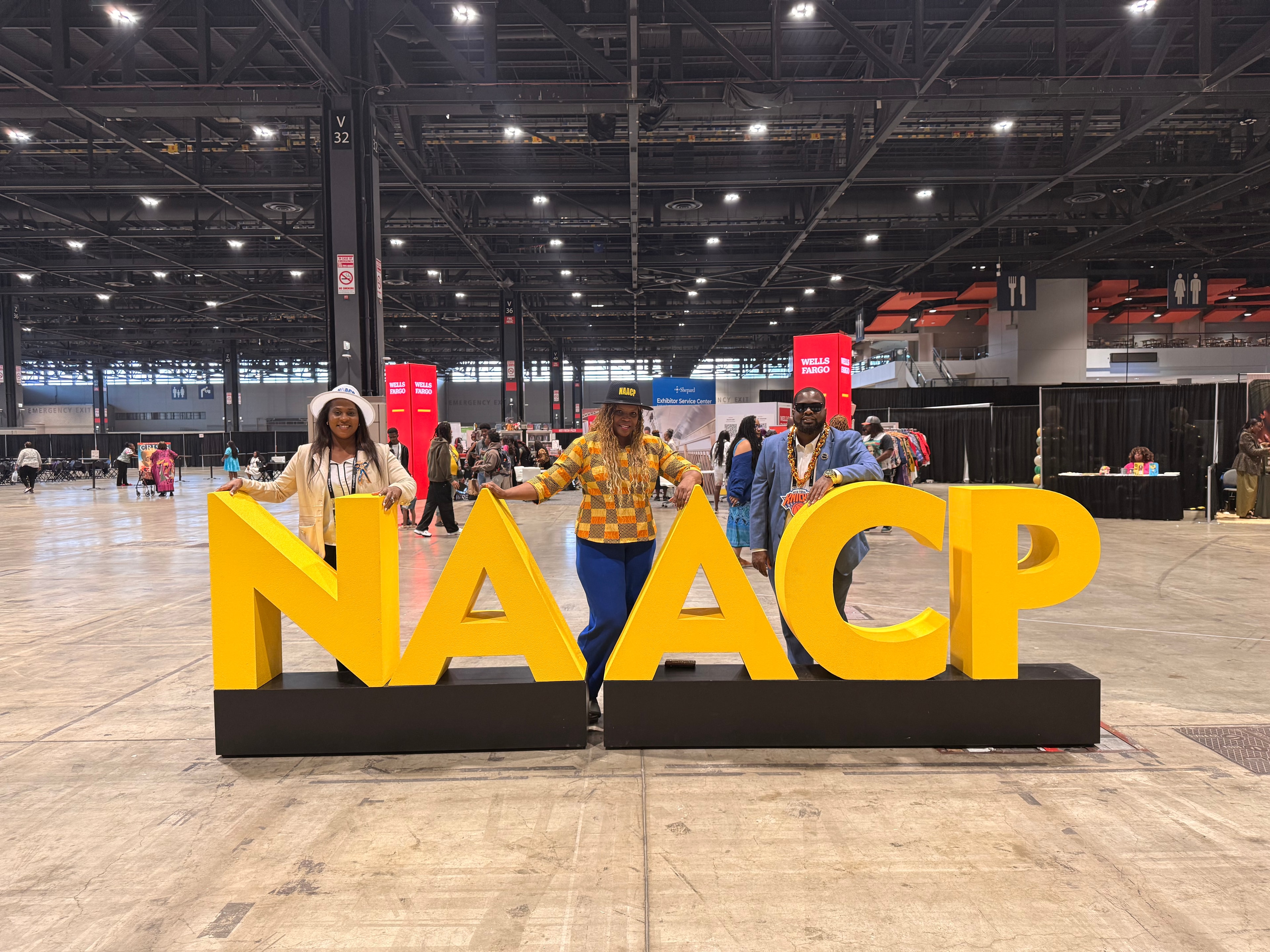 NAACP NYCHA Branch members posing with NAACP letters at a convention